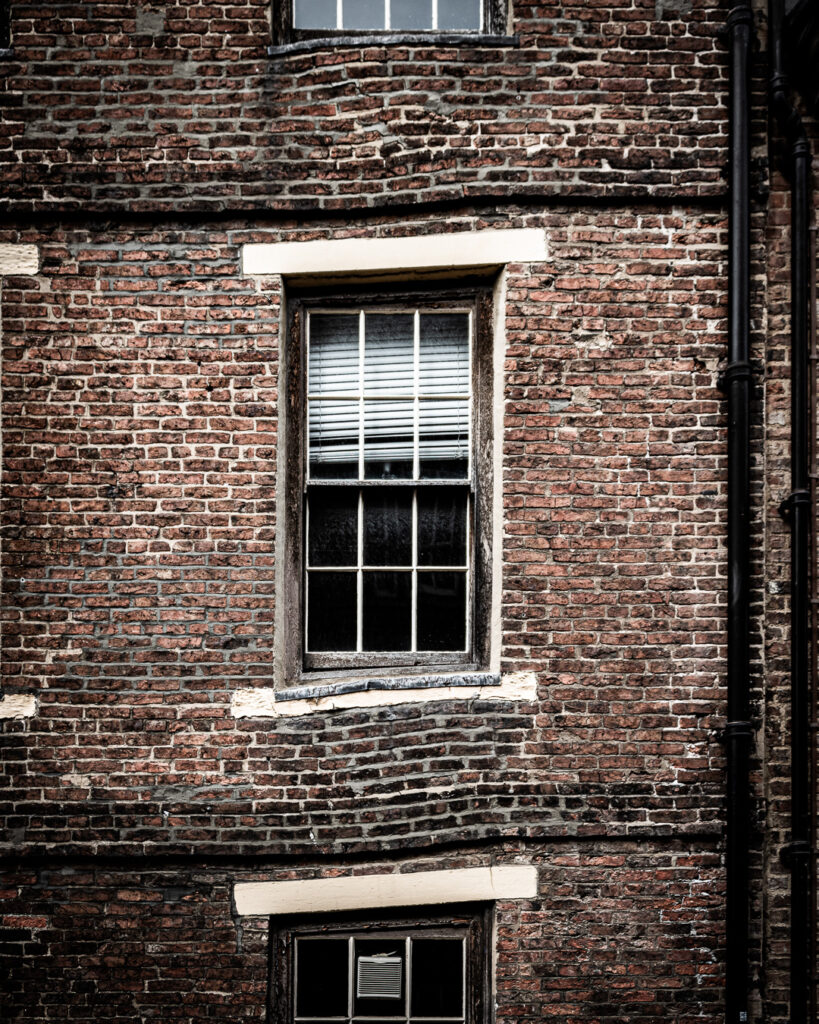 Georgian brick building with structural subsidence and skewed windows on North Bailey, Durham