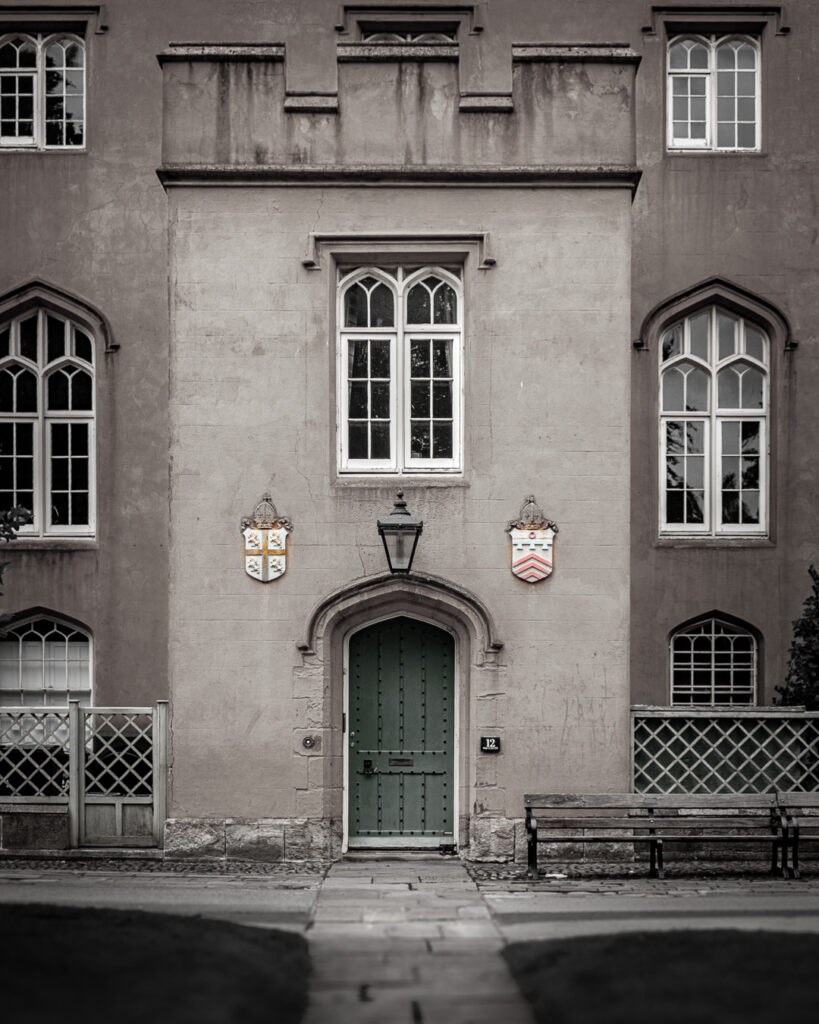 Gothic Revival building with heraldic shields and green door in Durham Chorister School's College precinct