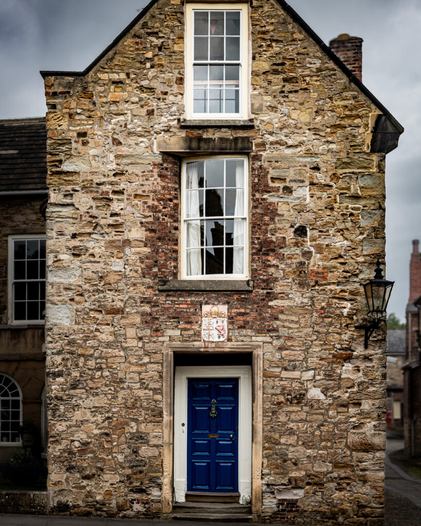 Historic stone building with blue door at Durham Chorister School's College area near South Bailey by Michael Dutson architecture photography
