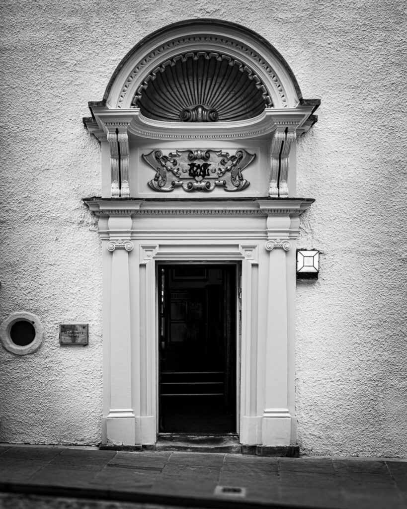 Grand neoclassical doorway with shell canopy and ornate carved details on South Bailey, Durham by Michael Dutson architectural photography